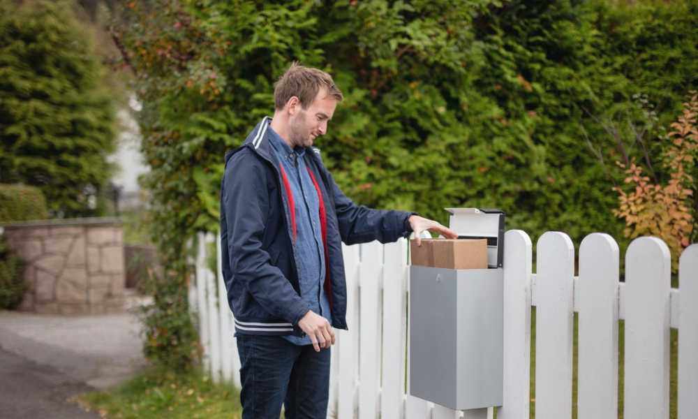 Customers picking up parcel from mailbox